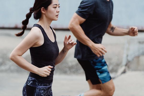 A calendar with marked days and a pair of running shoes, symbolizing routine.